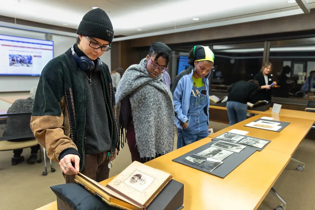 Students at the family pictures pop up exhibition at Bird Library.